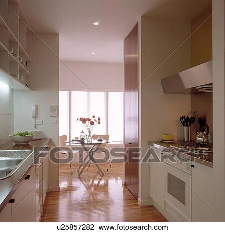 Openplan white modern galley kitchen View Large Photo Image Stock Image - Openplan white modern galley kitchen . Fotosearch