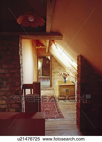 Stock Photography - Oriental rug and wooden chest in attic hall with wooden flooring. Fotosearch