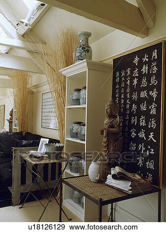 Oriental scoll above table with oriental sculpture View Large Photo Image Stock Photo - Oriental scoll above table with oriental sculpture. Fotosearch
