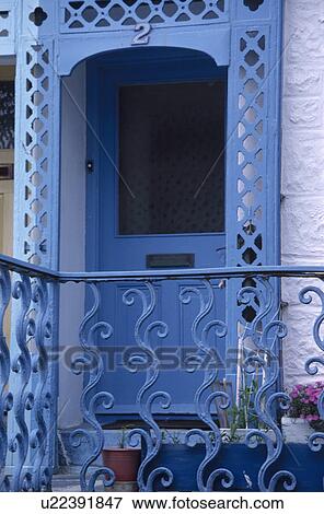 Stock Photo - Ornate blue railings in front of blue door with blue fretwork porch. Fotosearch