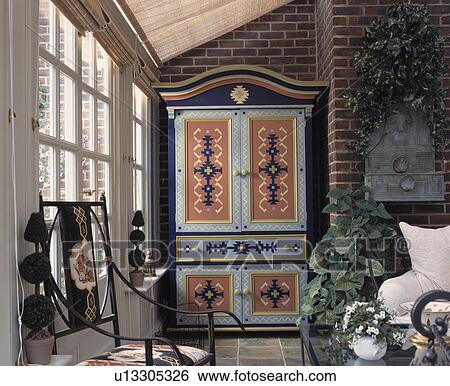 Painted wooden cupboard in living room View Large Photo Image Stock Photograph - Painted wooden cupboard in living room. Fotosearch