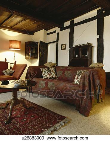 Paisley throw on sofa in country living room View Large Photo Image Stock Photo - Paisley throw on sofa in country living room. Fotosearch