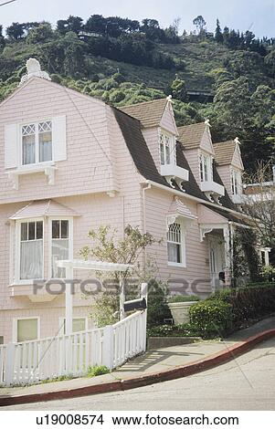 Picture - Pastel pink clapboard house in the country. Fotosearch