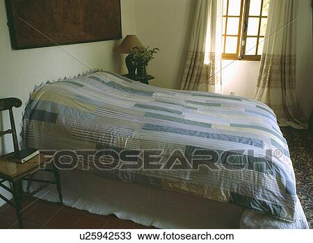 Patchwork quilt on bed in cottage bedroom View Large Photo Image Stock Image - Patchwork quilt on bed in cottage bedroom. Fotosearch