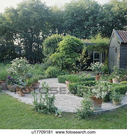 Patio in country garden in summer View Large Photo Image Stock Image - Patio in country garden in summer. Fotosearch
