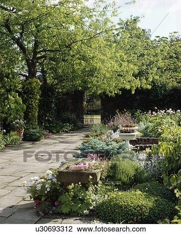 Patio in country garden in summer View Large Photo Image Stock Image - Patio in country garden in summer. Fotosearch