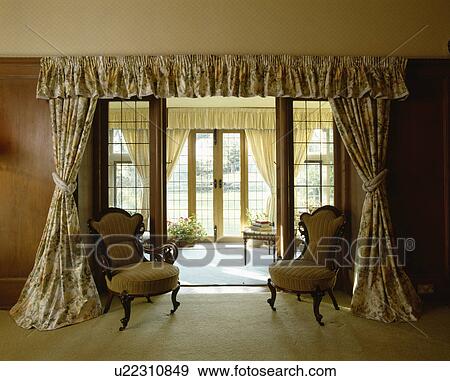 Stock Photo - Patterned curtains at internal doors in traditional living room. Fotosearch