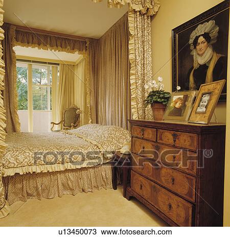 Patterned Drapes And Bed Linen On Four Poster Bed In Neutral