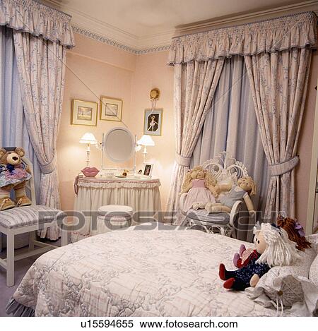 Patterned pink curtains in child's pink bedroom with lighted lamps on skirted dressing table View Large Photo Image Stock Photography - Patterned pink curtains in child's pink bedroom with lighted lamps on skirted dressing table. Fotosearch