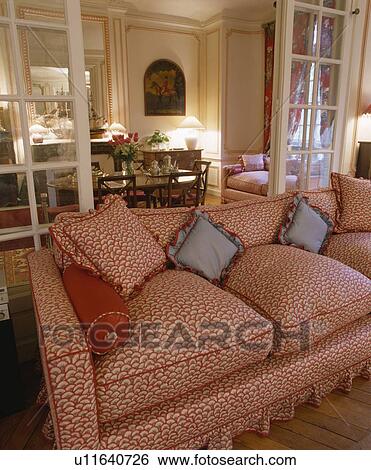 Patterned red sofa in traditional apartment living room View Large Photo Image Stock Photograph - Patterned red sofa in traditional apartment living room. Fotosearch