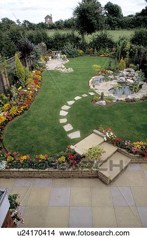 Picture - Paving steps across lawn to small pond in country garden. Fotosearch