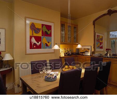 Pendant lamps above rectangular wooden table in yellow dining room with large picture View Large Photo Image Stock Image - Pendant lamps above rectangular wooden table in yellow dining room with large picture. Fotosearch