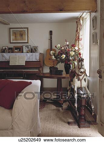 Piano in traditional cottage living room View Large Photo Image Stock Photo - Piano in traditional cottage living room. Fotosearch