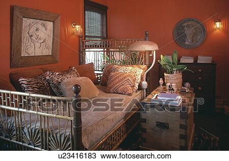 Picture above bamboo bed with animalprint cushions in orange bedroom with wooden chest View Large Photo Image Stock Image - Picture above bamboo bed with animalprint cushions in orange bedroom with wooden chest. Fotosearch