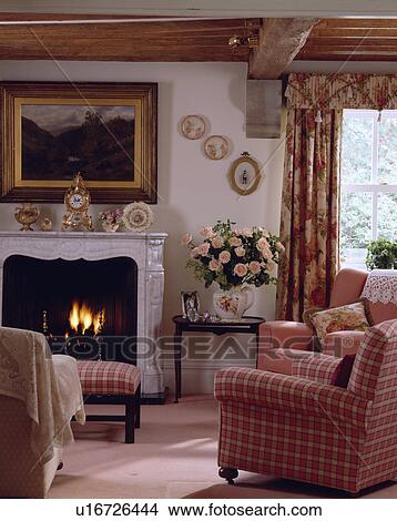 Picture above fireplace in cottage living room with red checked armchair View Large Photo Image Picture - Picture above fireplace in cottage living room with red checked armchair. Fotosearch