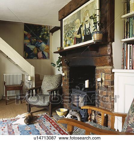 Picture above fireplace with black iron stove in cottage living room View Large Photo Image Stock Photo - Picture above fireplace with black iron stove in cottage living room. Fotosearch