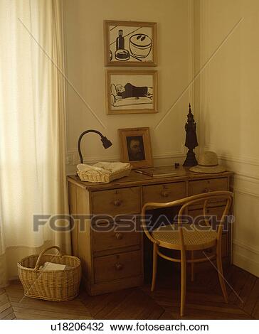 Stock Image - Pictures above pine desk with Bentwood chair. Fotosearch