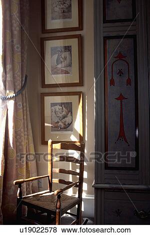 Pictures above rush-seated chair View Large Photo Image Stock Photo - Pictures above rush-seated chair. Fotosearch
