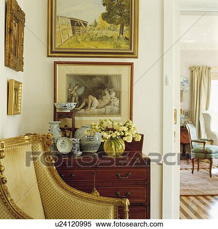 Stock Photography - Pictures on wall above chest in traditional living room. Fotosearch