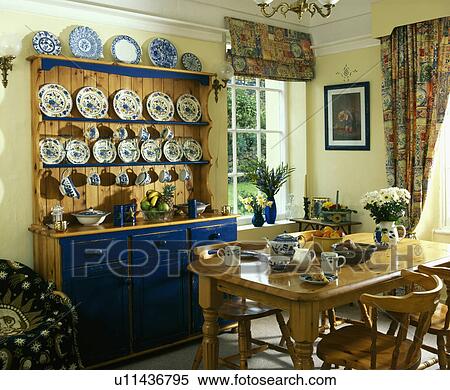 Stock Photography - Pine dresser with with ining room with pine table and chairs . Fotosearch