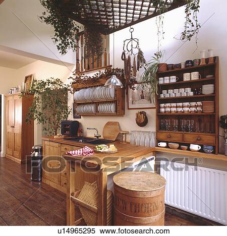 Pine shelves and plate rack in kitchen extension with white radiator and wooden flooring View Large Photo Image Stock Photography - Pine shelves and plate rack in kitchen extension with white radiator and wooden flooring. Fotosearch
