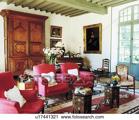 Pink Armchairs And Antique Cupboard In Traditional French Country