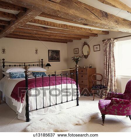 Pink Throw And White Linen On Wrought Iron Bed In Beamed Cottage Wrought Iron Bed In Beamed Cottage
