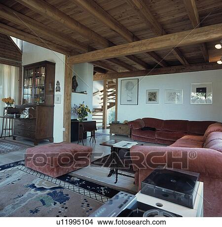 Picture - Pink velour sofas in eighties-style living room with beamed ceiling. Fotosearch