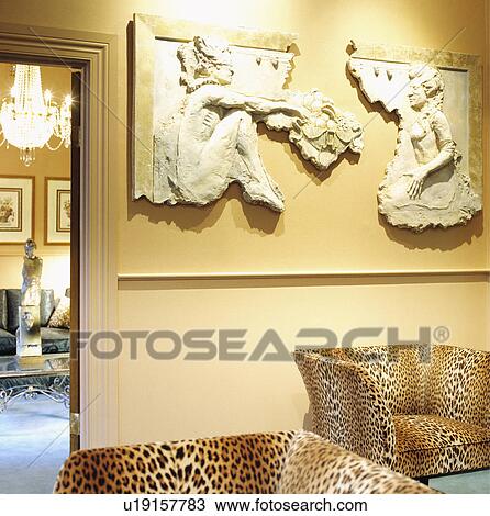 Plasterwork picture on wall above animalprint armchairs View Large Photo Image Stock Image - Plasterwork picture on wall above animalprint armchairs. Fotosearch