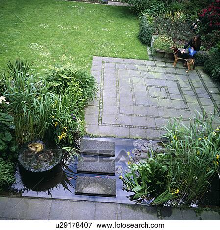 Stock Photo - Pond and paving in town garden. Fotosearch