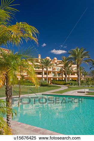 Rectangular turquoise swimmingpool in front of neutral modern apartment building in southern Spain View Large Photo Image Stock Photography - Rectangular turquoise swimmingpool in front of neutral modern apartment building in southern Spain. Fotosearch