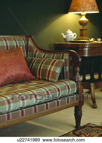 Red And Green Check Upholstery On Antique Sofa In Dark Green