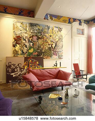 Stock Photo - Red cushions on sofa in modern living room. Fotosearch