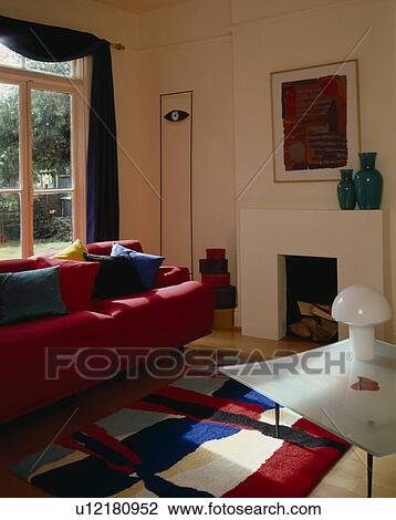 Stock Image - Red sofa in modern living room. Fotosearch