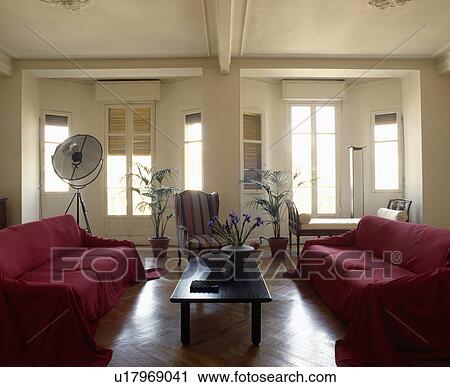 Stock Image - Red sofas in traditional living room with parquet floor. Fotosearch