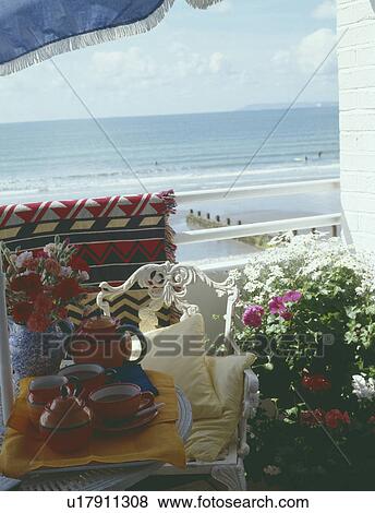 Red teaset on small balcony table with view of the sea View Large Photo Image Stock Photo - Red teaset on small balcony table with view of the sea. Fotosearch
