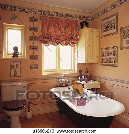 Rolltop bath and patterned festoon blind in bathroom with decoupage black+white prints and border View Large Photo Image Stock Image - Rolltop bath and patterned festoon blind in bathroom with decoupage black+white prints and border. Fotosearch