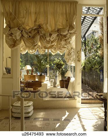 Stock Image - Ruched blind in living room. Fotosearch