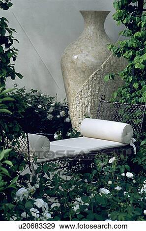 Stock Photo - Sculpture in modern town garden. Fotosearch
