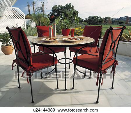 Stock Photo - Seating and furniture on patio of Spanish villa. Fotosearch