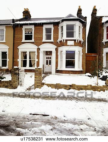 Stock Image - Semi-detached Edwardian house in the snow. Fotosearch