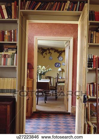 Shelves over open door with view across tiled hall floor to country dining room View Large Photo Image Stock Photograph - Shelves over open door with view across tiled hall floor to country dining room. Fotosearch