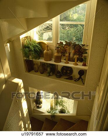 Sisal carpet on staircase below window with wicker bottles on shelves View Large Photo Image Stock Photo - Sisal carpet on staircase below window with wicker bottles on shelves . Fotosearch