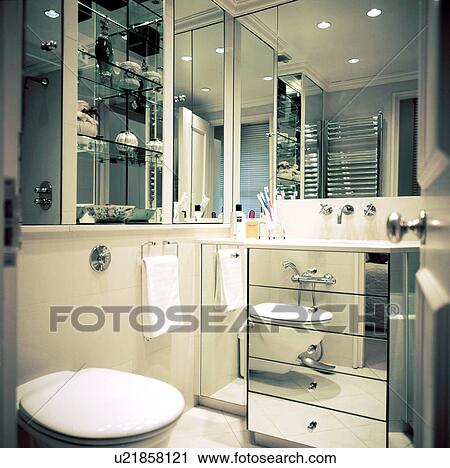 Small contemporary white mirrored bathroom View Large Photo Image Stock Image - Small contemporary white mirrored bathroom . Fotosearch