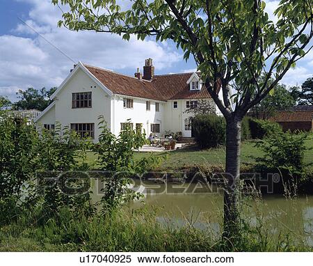 Small river in front of large cream house in the country View Large Photo Image Stock Photography - Small river in front of large cream house in the country. Fotosearch