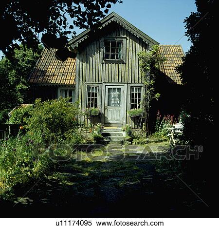Stock Photography - Small wood clad country cottage. Fotosearch