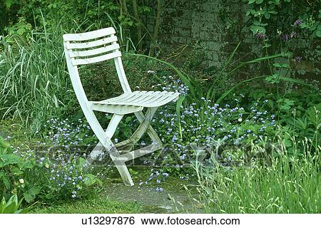 Small wooden chair in country garden in summer View Large Photo Image Stock Photograph - Small wooden chair in country garden in summer. Fotosearch
