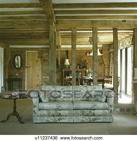 Sofa in front of exposed wall beams in country living room View Large Photo Image Stock Photograph - Sofa in front of exposed wall beams in country living room. Fotosearch