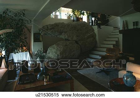 Stock Photography - Staircase beside living rock in country living room. Fotosearch