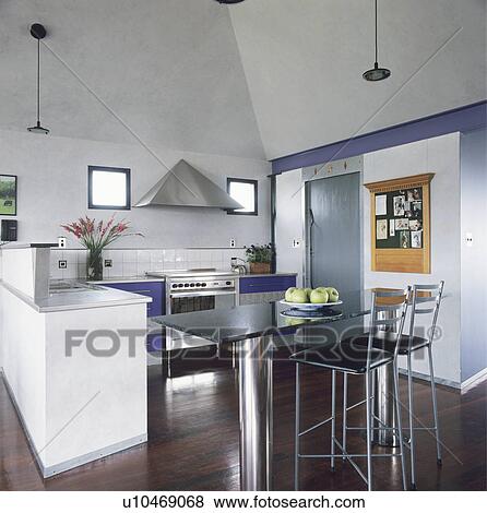 Steel Pedestal Table And Stools In Modern White Kitchen With